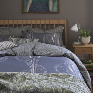 bedding with table lamp and drawer