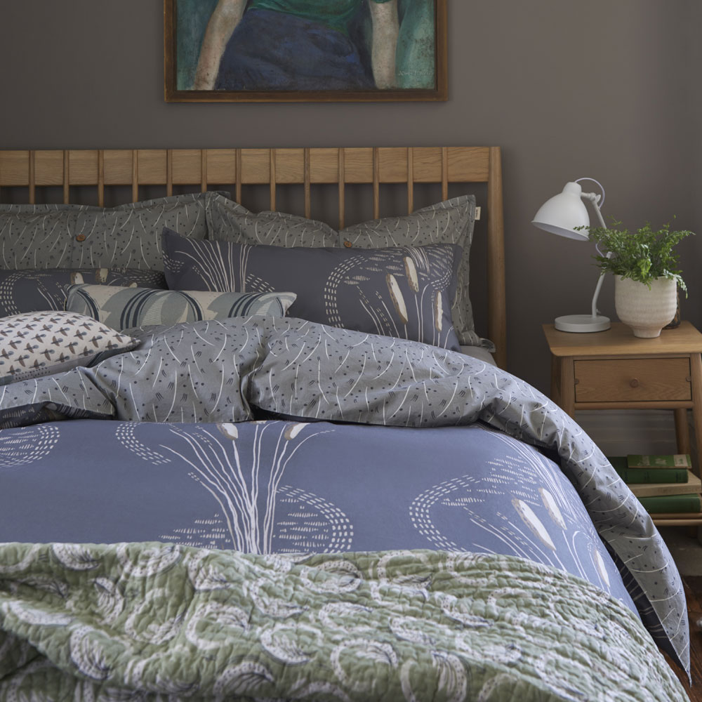 bedding with table lamp and drawer