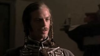 A close up of Keith Carradine with a mustache and braids in his hair from The Duallists
