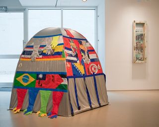 A tent with the flags of a range of nations.