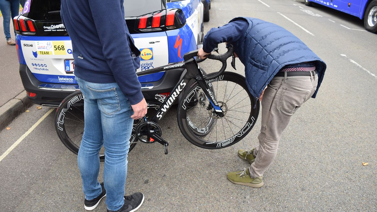 Quick-Step Floors mechanics check disc rotor alignment on the team bikes ahead of the stage 3 start
