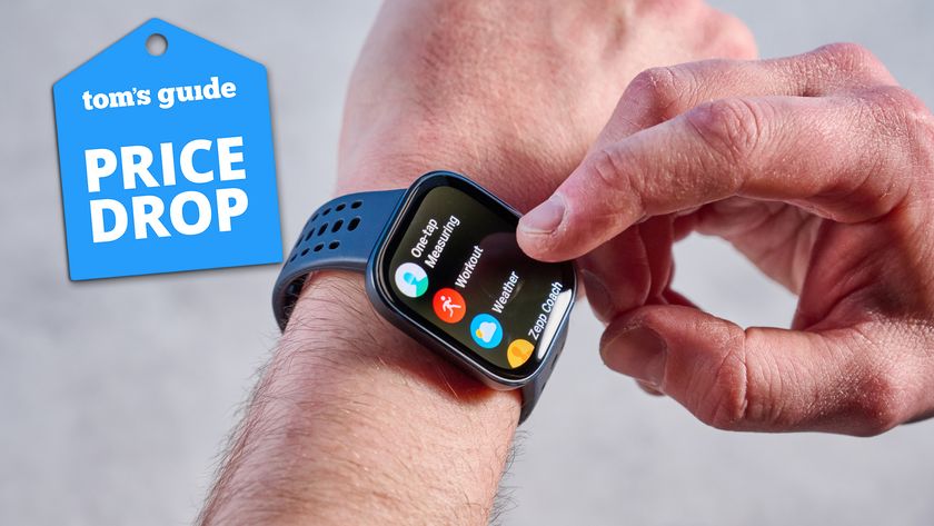 Amazfit Bip 6 on a man&#039;s arm on a grey background with a blue price drop tag.