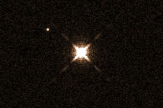 This image from the Hubble Space Telescope shows the star HAT-P-11 (center), which has a Neptune-size planet that is the smallest yet known to have water in its atmosphere. The planet, HAT-P-11b, is not visible in this image. The other bright object seen here is another star.