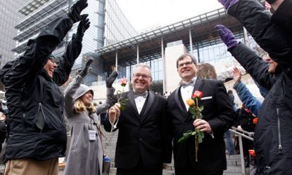 Newlyweds walk past cheering well-wishers after getting married in Seattle
