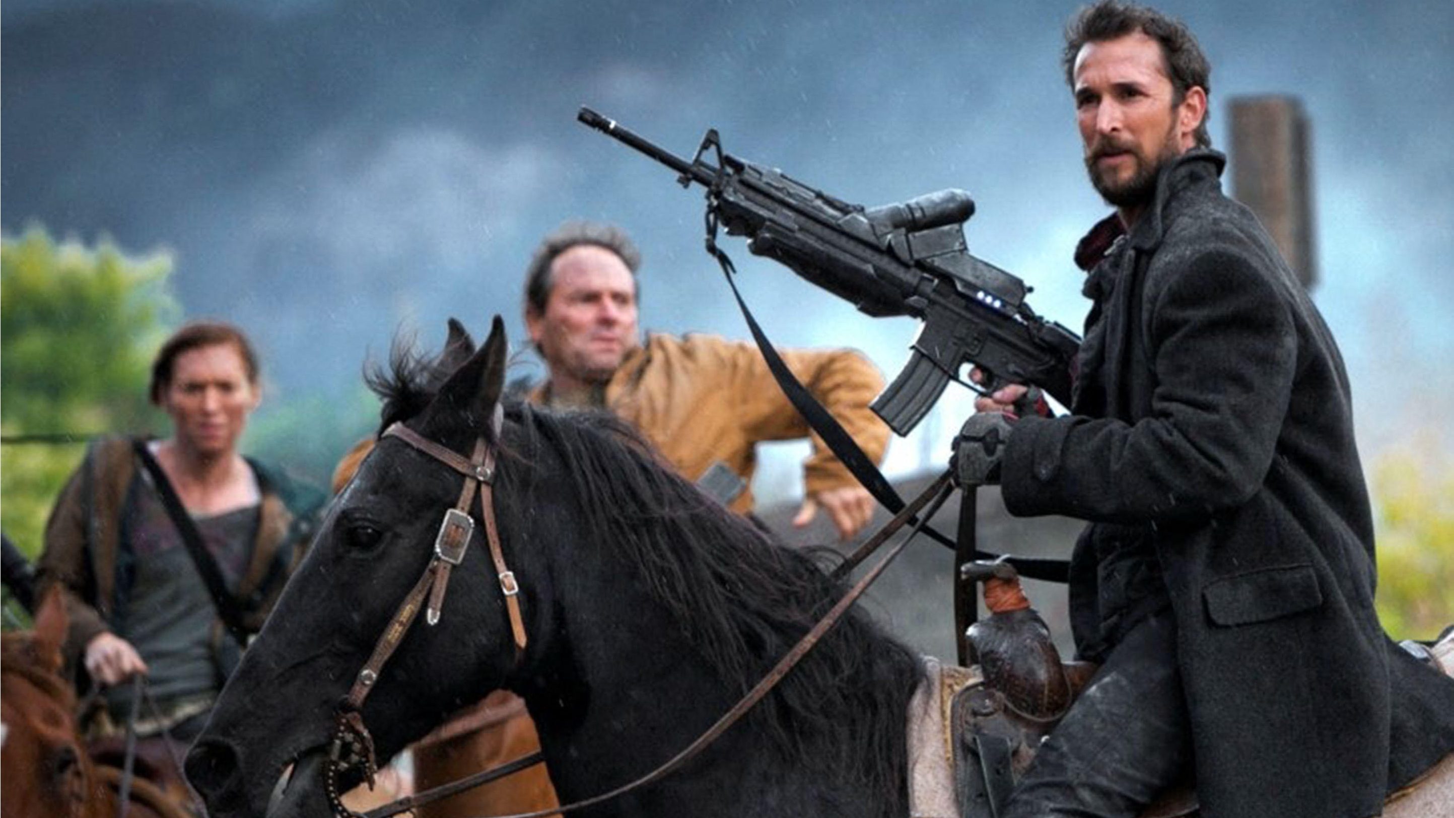 Tim Mason (Noah Wyle) on horseback and wielding a rifle in a scene from "Falling Skies"