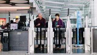 Passengers using security gates at an airport