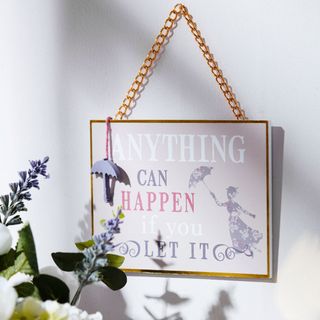 mary poppins with white wall and wall plaque