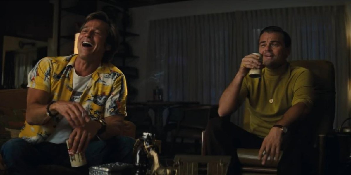 Once Upon A Time In Hollywood Brad Pitt and Leonardo DiCaprio laugh over some drinks in the living r