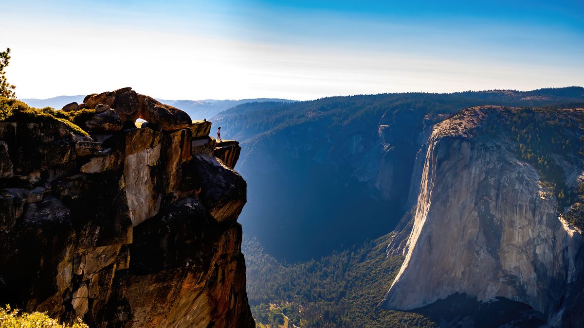 Person standing on Taft Point, Yosemite National Park, USA