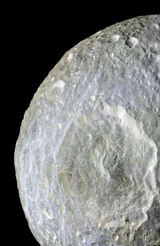 Subtle color differences on Saturn's moon Mimas are apparent in this false-color view of Herschel Crater captured by NASA's Cassini spacecraft during its closest-ever flyby of that moon on Feb. 13, 2010. The crater is 80 miles (130 kilometers) wide.