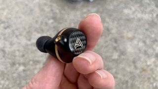 Audeze Euclid held in a woman's hand