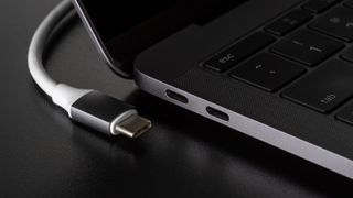 The USB-C cable resting beside a USB-C port on a laptop