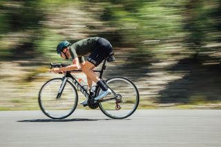 Male cyclist riding a bike with a long crank length