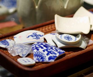 broken blue crockery on a tray