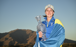Linn Grant wrapped in the Swedish flag holding the Solheim Cup