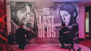 A shot of artist Tom Wells painting a mural based on the Last of Us of the two protagonists