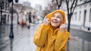 woman walking in city wearing raincoat