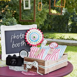 garden decorated for a photo area with camera and a board