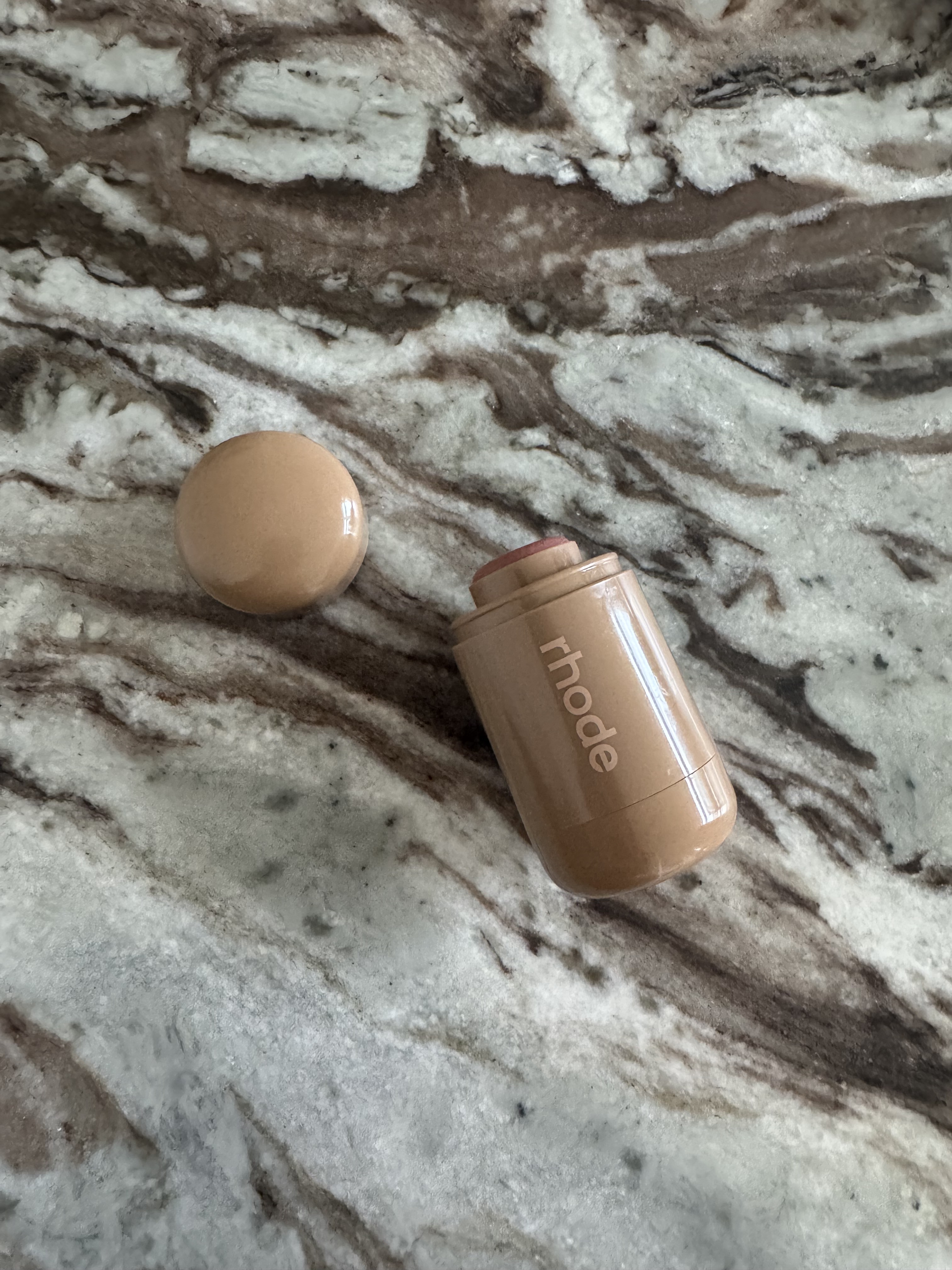 The Rhode Pocket Blush in shade tan line, with the lid off