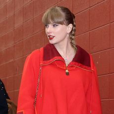 Taylor Swift wearing a red Louis Vuitton sweater at Arrowhead Stadium