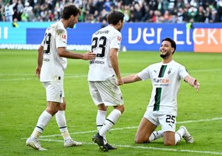 Ramy Bensebaini of Borussia Monchengladbach celebrates with teammates after scoring their team's fourth goal during the Bundesliga match between Borussia Mönchengladbach and 1. FC Köln at Borussia-Park on October 09, 2022 in Moenchengladbach, Germany.