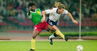 England winger Chris Waddle (r) is challenged by Jean-Claude Pagal of Cameroon during the 1990 FIFA World Cup Quarter Final match on July 1, 1990 in Naples, Italy