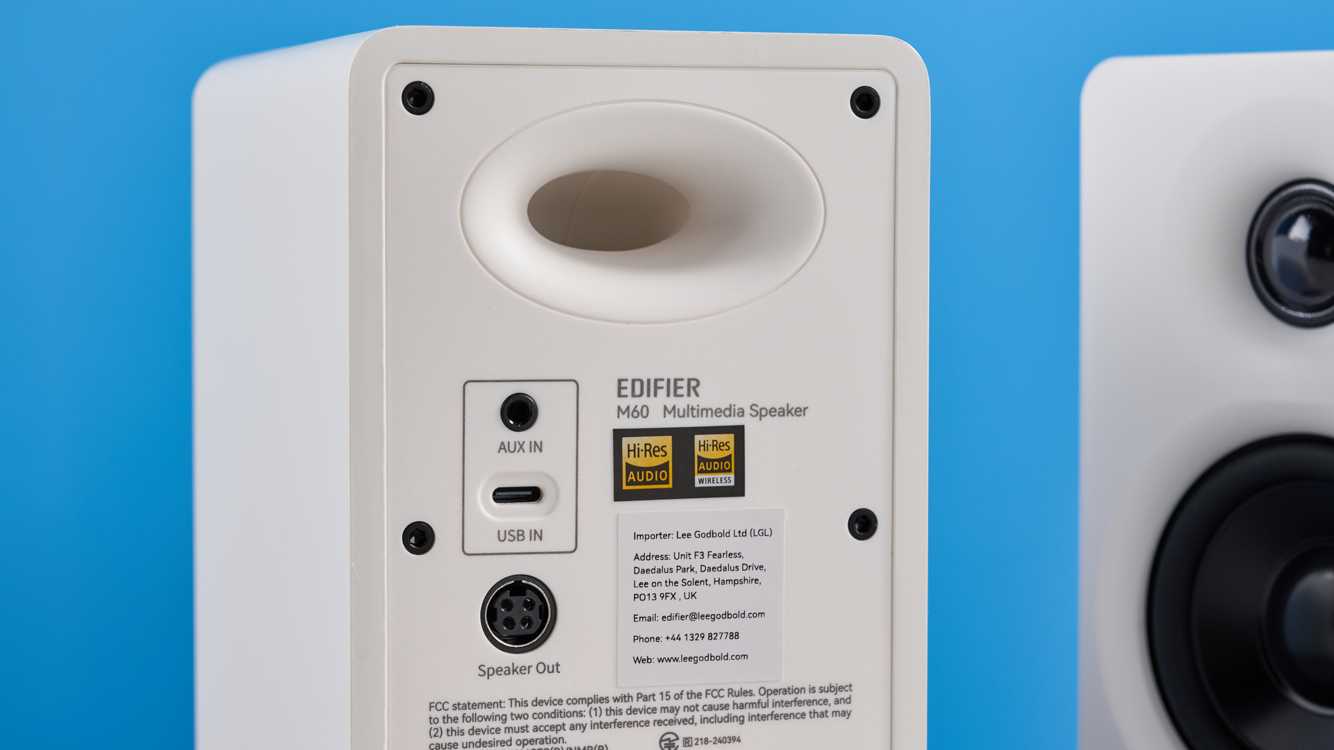 the edifier m60 bookshelf speakers in white photographed against the blue tom's guide background