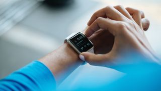 Person using their smartwatch to time their workouts