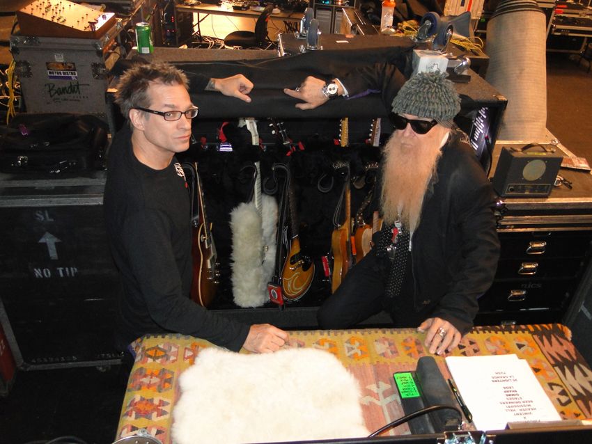 Francis and Gibbons show off a road case filled with guitar goodness