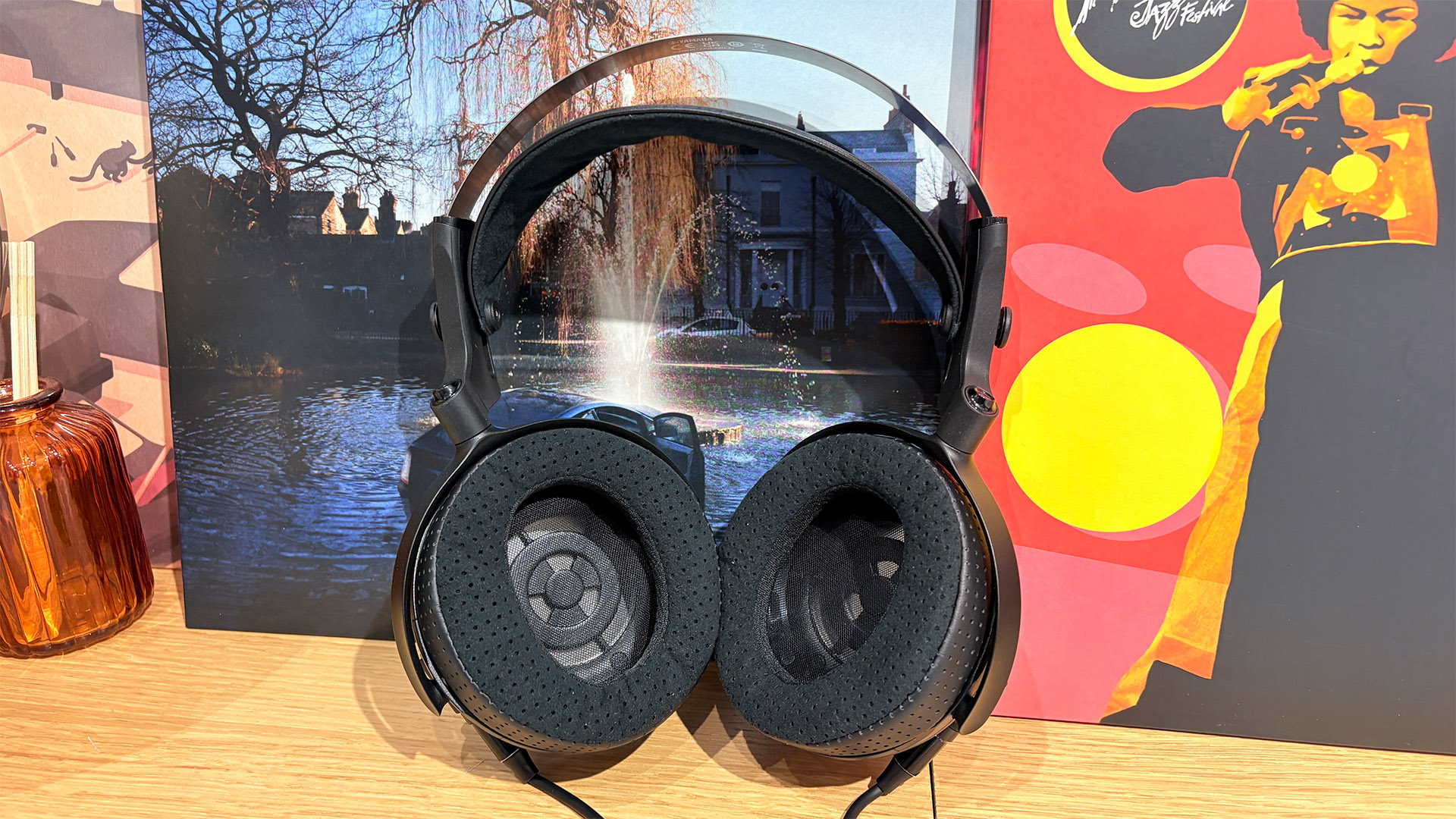 Yamaha YH-4000 open-back wired headphones on busy bookshelf