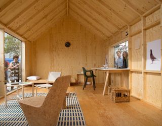 The inside features a minimalist, plywood-clad interior furnished with his designs.