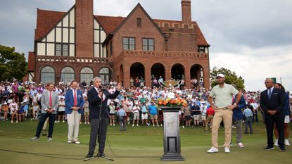 Scottie Scheffler is awarded the FedEx Cup by PGA Tour commissioner Jay Monahan