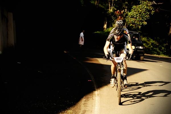 Alex Grant climbs on pavement.