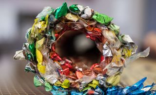 Close up of a rolled up panel of colourful foil, blurred background