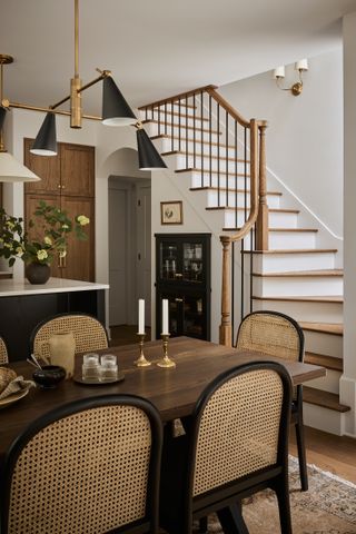 a kitchen diner with storage built under the stairs