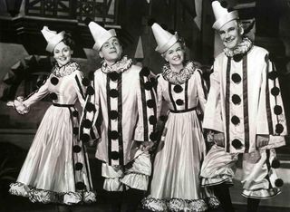 two men and women dressed in elaborate clown costumes in Yankee Doodle dandy