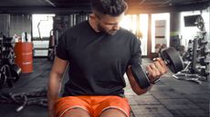 Man doing superset dumbbell bicep curls