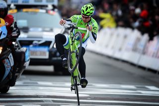 Peter Sagan celebrates with a wheelie as he wins Gent-Wevelgem 2013