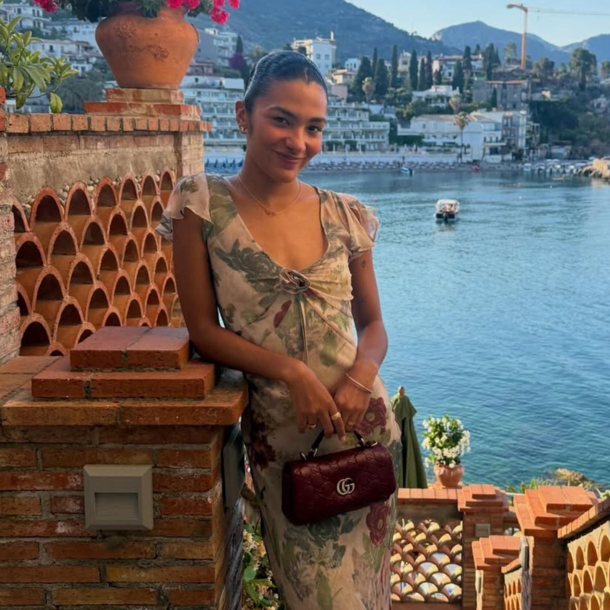 An image of Olivia Dean wearing the Realisation Par Meg dress, one of the biggest rosette dress trend.