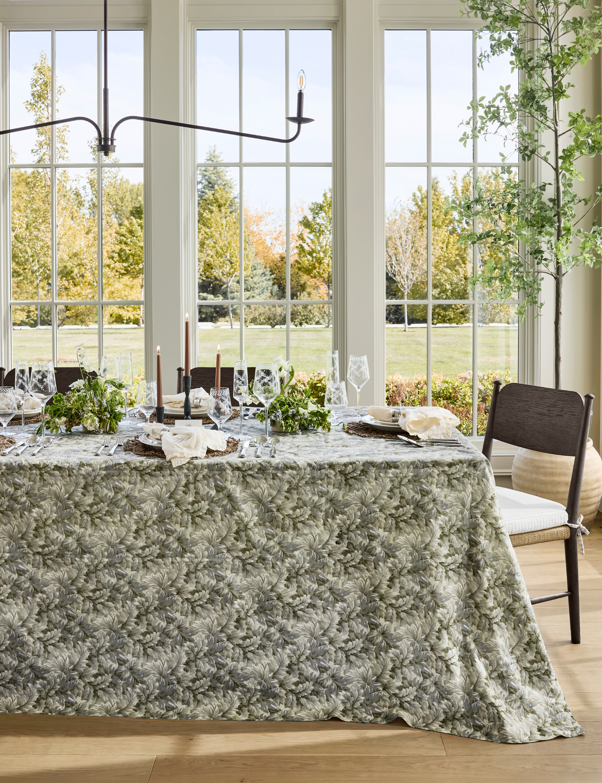 Bright fall dining room styled with a tapestry-inspired tablecloth and nostalgic dinnerware