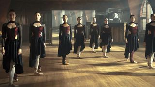 A group of female ballet dancers in a dance studio.