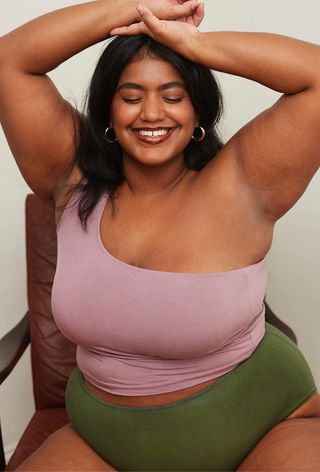 a photo of a woman wearing period panties and a tank top