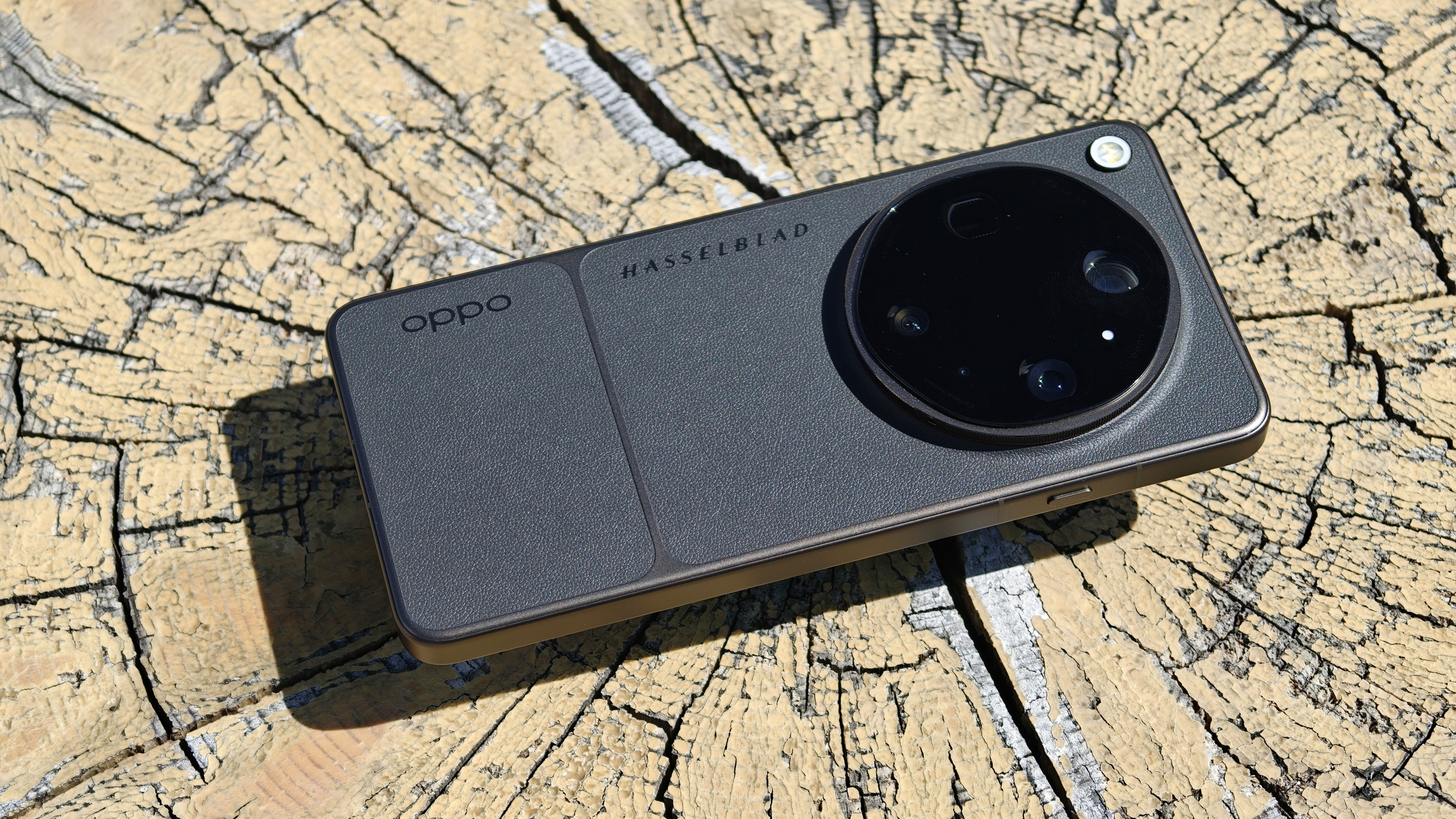 Oppo Find X9 Ultra phone on a cracked wooden surface