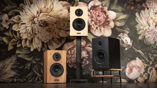 Three finishes of Dellichord speakers against a floral background