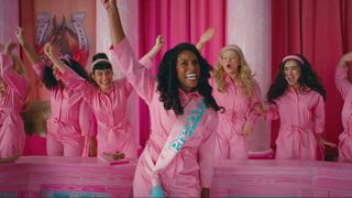 Issa Rae wearing a pink jumpsuit and a president sash in the Barbie movie