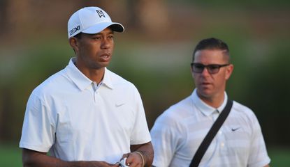 Tiger Woods walks down the fairway with coach, Sean Foley