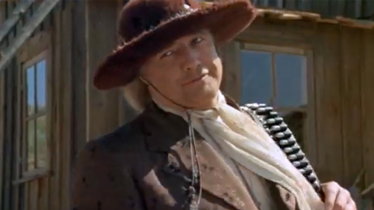Marlin Brando smirking and wearing a fuzzy red hat in The Missouri Breaks