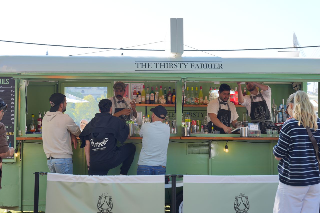 Customers ordering drinks at The Thirsty Farrier cocktail bar.