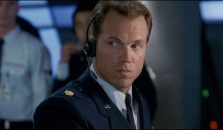Independence Day Adam Baldwin sits with a headset on