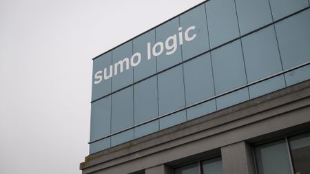 Sumo Logic logo pictured on the side of the company's headquarters in Redwood City, California, U.S, with grey skies in background.